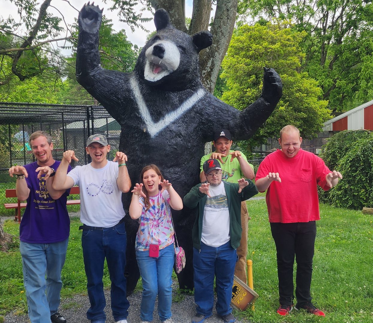 Friends having fun with bear statue