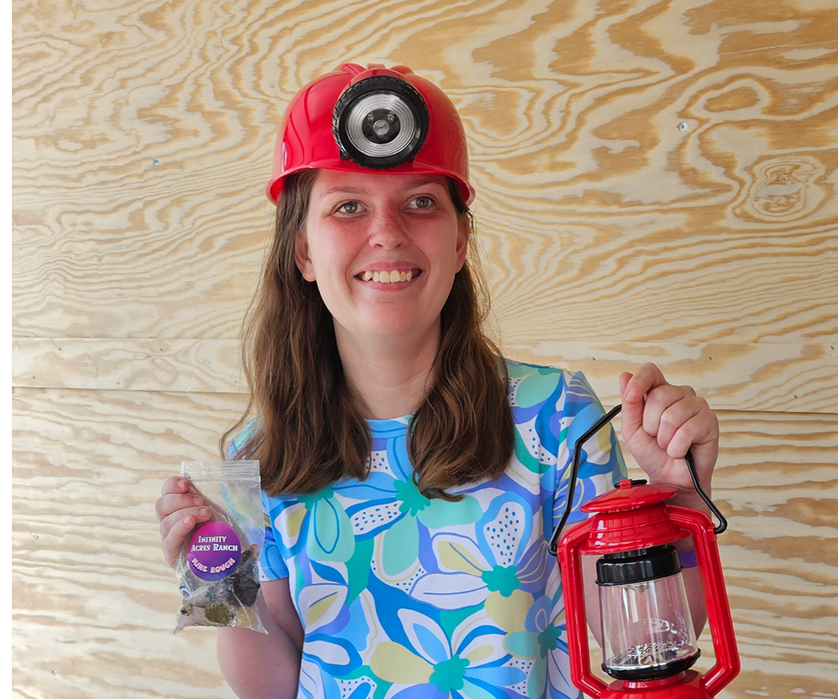 Smiling woman holding lantern and bag