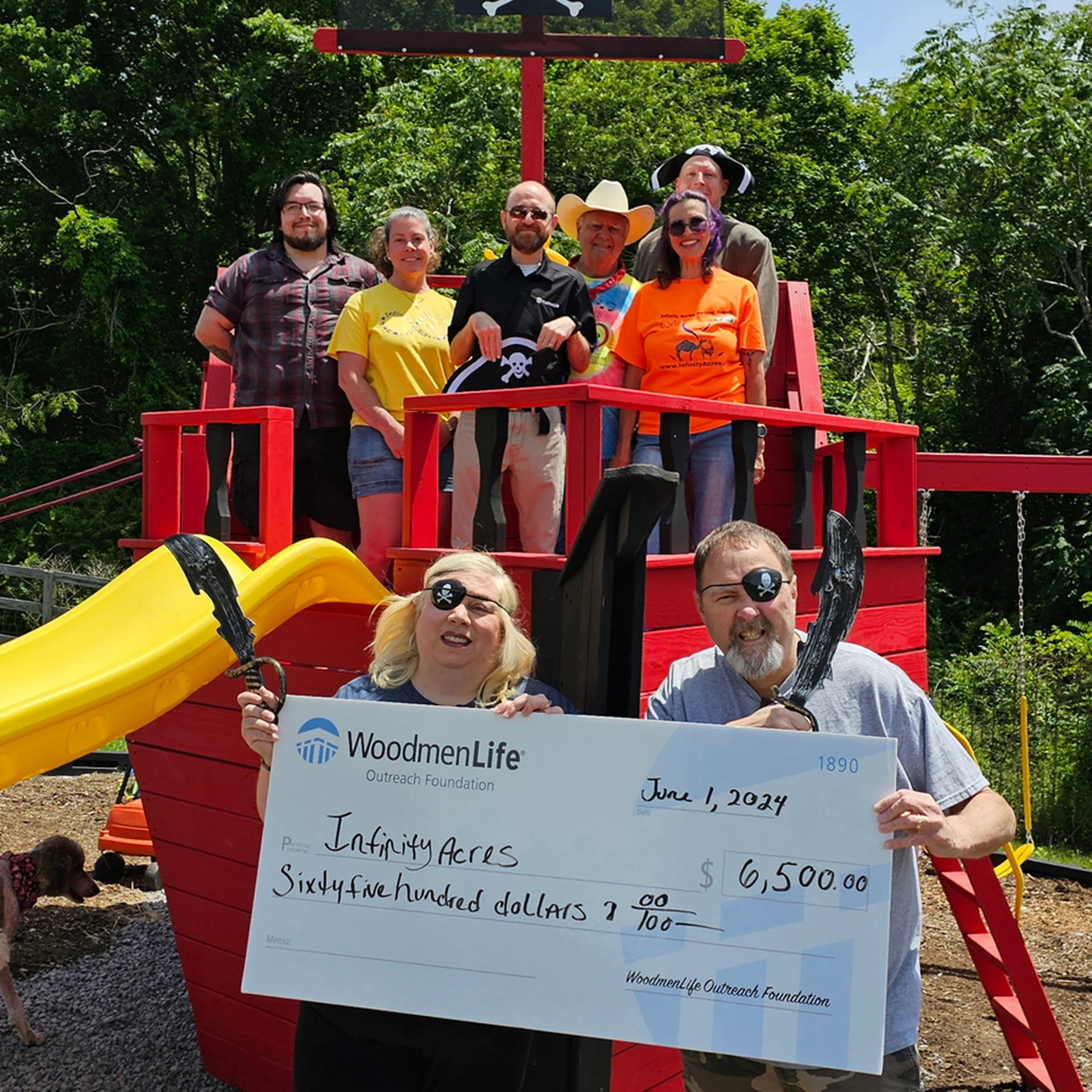 Group posing with large donation check