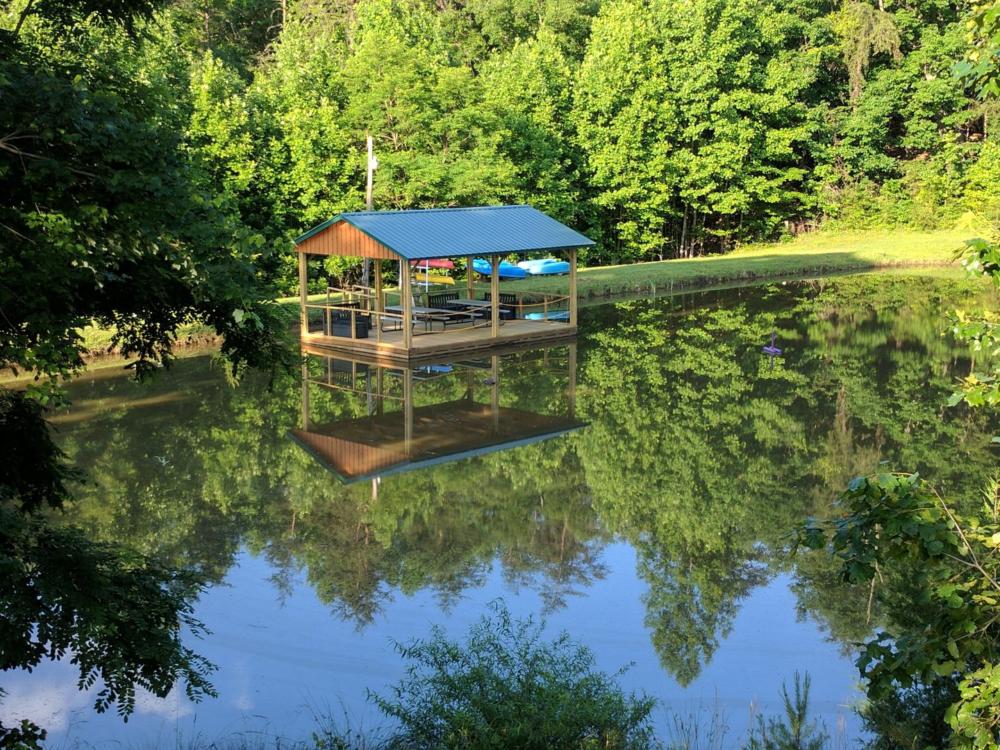 Lakeside shelter with forest reflection