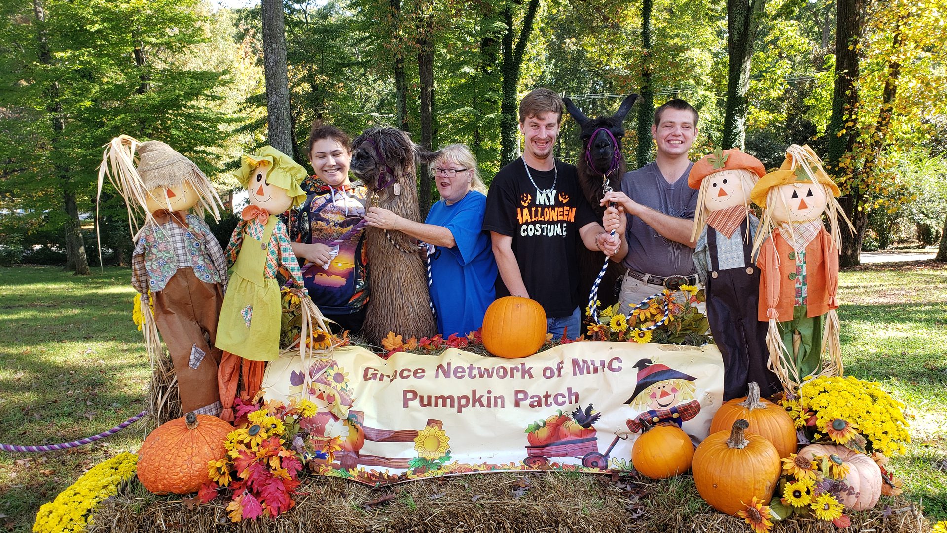 Smiling group at festive fall display
