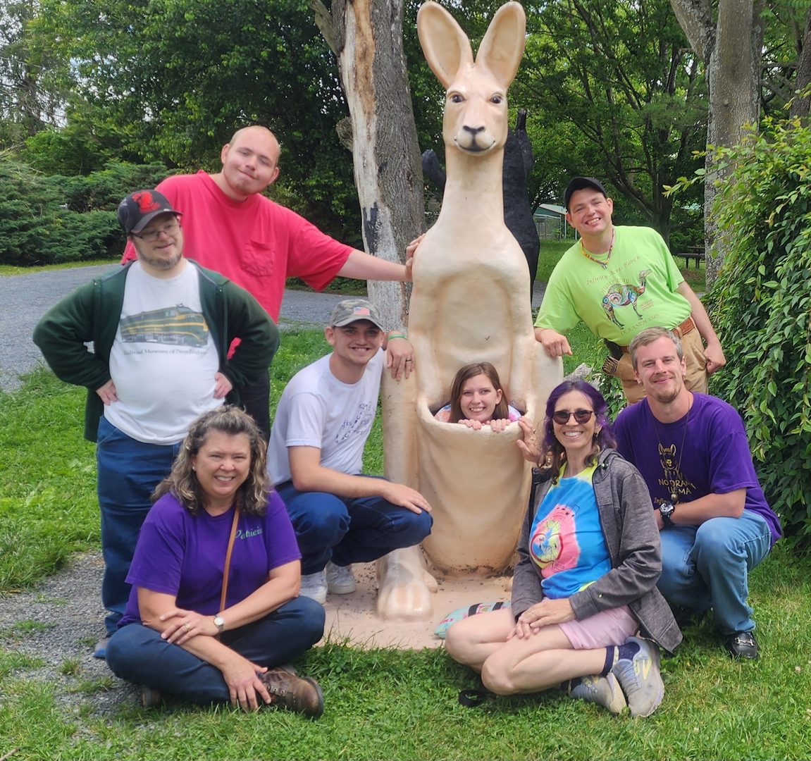 Group posing with large kangaroo statue