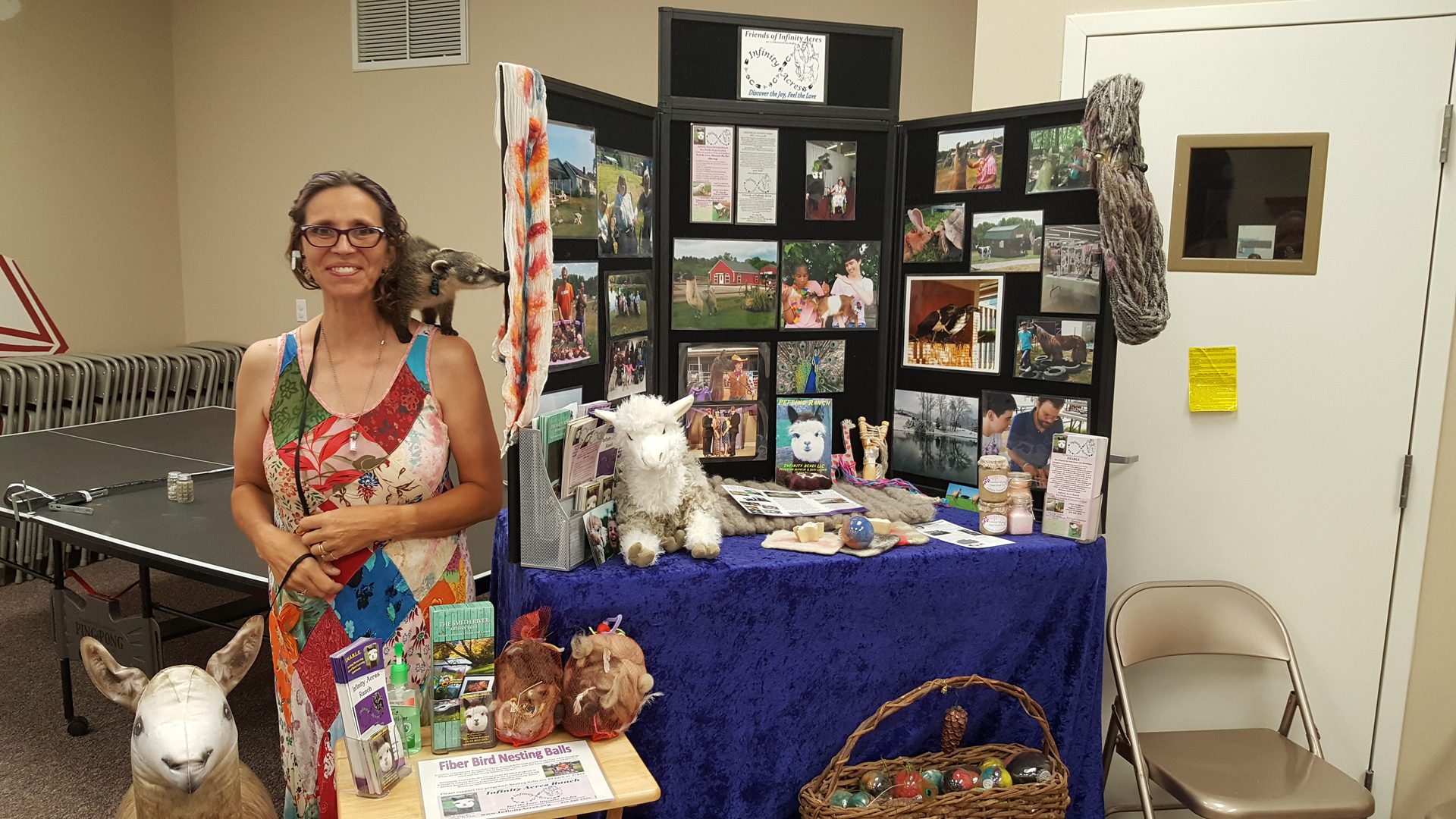 Woman showcasing handmade alpaca items