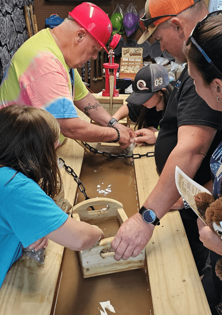 People working together on a woodworking project at a table.